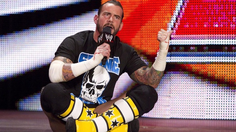 CM Punk sits on the stage and delivers the infamous "Pipe Bomb" promo in WWE.