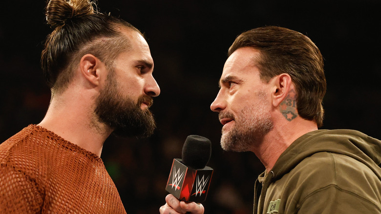 Seth Rollins and CM Punk speak during Monday Night RAW at Angel of the Winds Arena on December 2, 2024 in Everett, Washington.