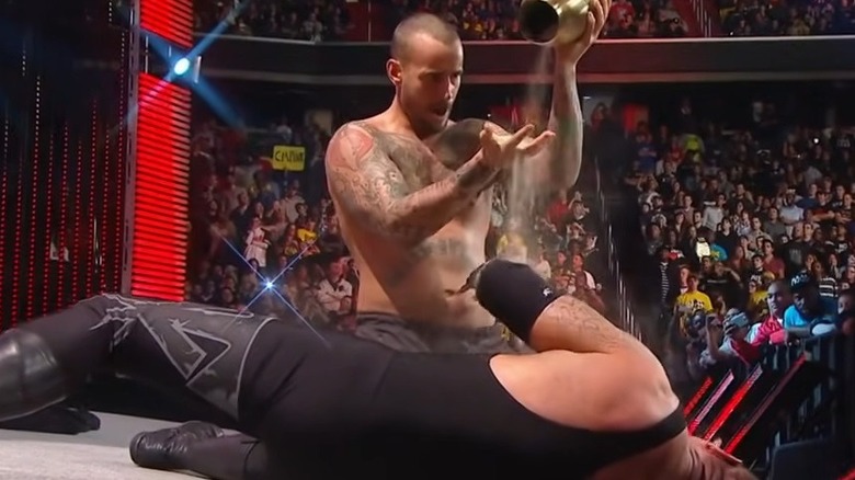 CM Punk pouring ashes over The Undertaker