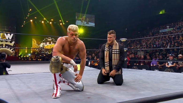 Cody Rhodes kneels next to MJF