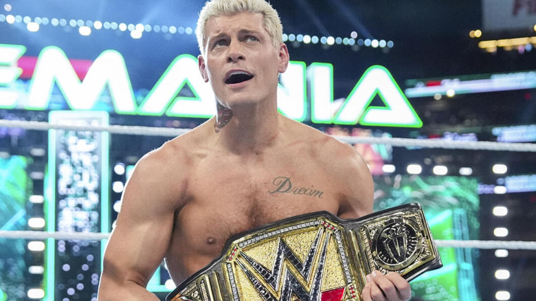 Cody Rhodes kneels in the ring at WrestleMania 40, Undisputed WWE Championship in his hands.