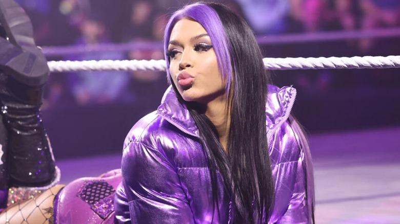 Cora Jade laying on the ring apron