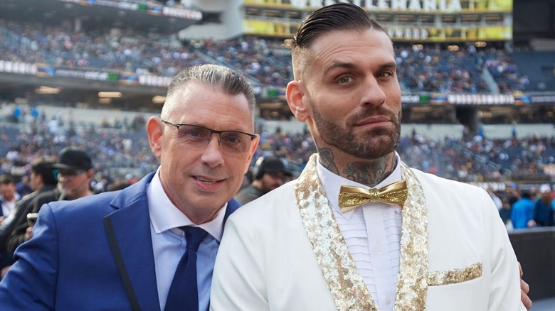 Corey Graves poses next to Michael Cole at WrestleMania 39