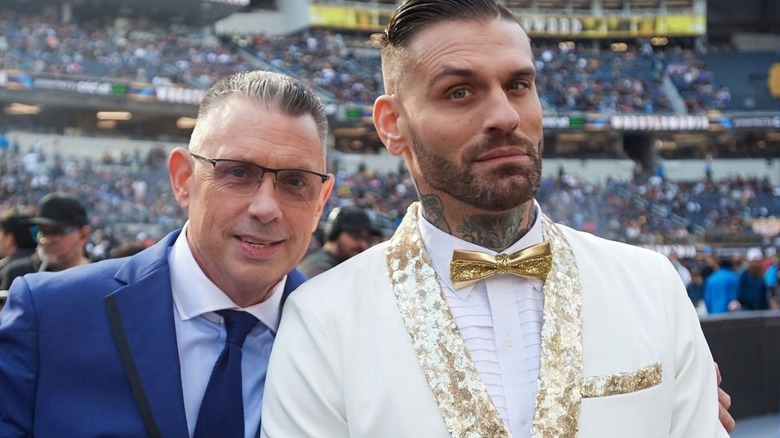 Corey Graves poses next to Michael Cole at WrestleMania 39.