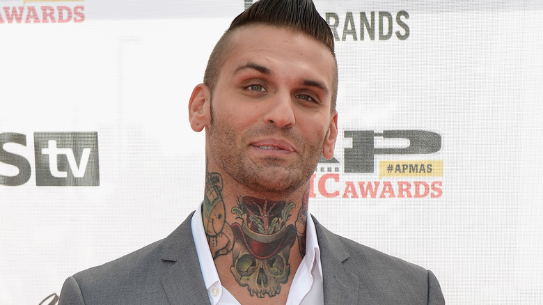 Corey Graves wearing a gray suit