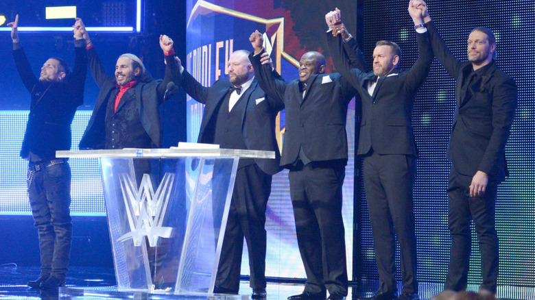The Hardys, Dudley Boyz, Christian, and Edge standing on a stage