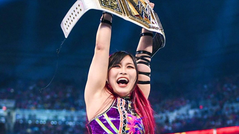 IYO SKY holding up the women's championship 