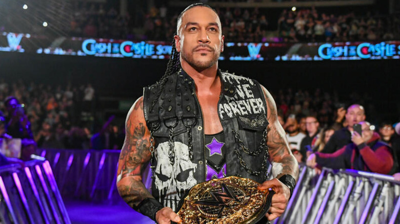 Damian Priest holding the WWE World Heavyweight Championship 