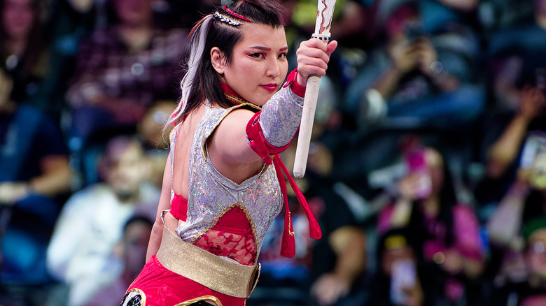Hikaru Shida poses with kendo stick