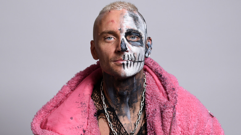 Darby Allin wearing a pink fur coat