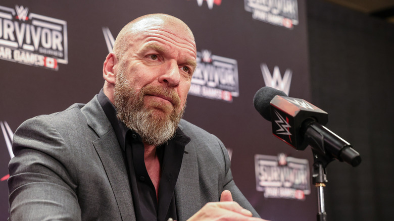 Triple H awaits a question from media personnel during a Survivor Series media scrum