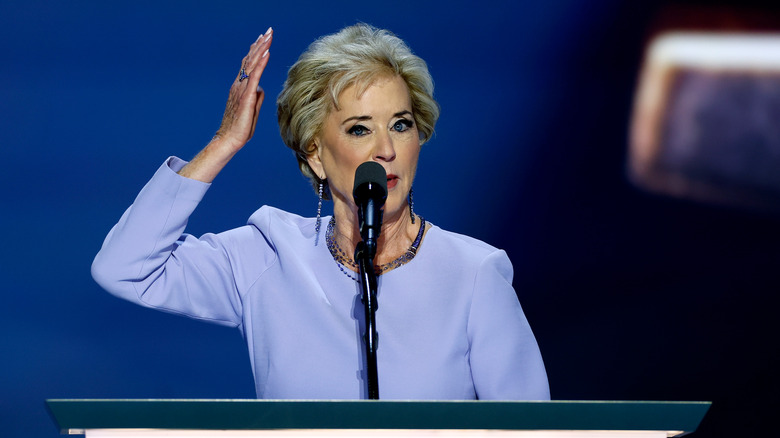 Linda McMahon preparing to karate chop something