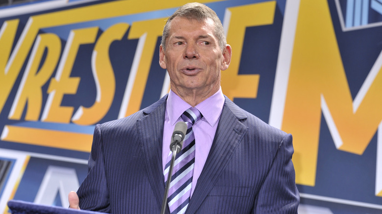 Vince McMahon in front of a WWE WrestleMania backdrop