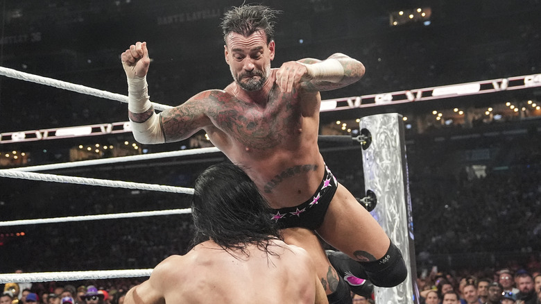 CM Punk flies towards Drew McIntyre