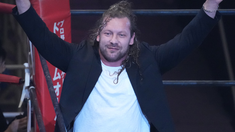 Kenny Omega raising arms