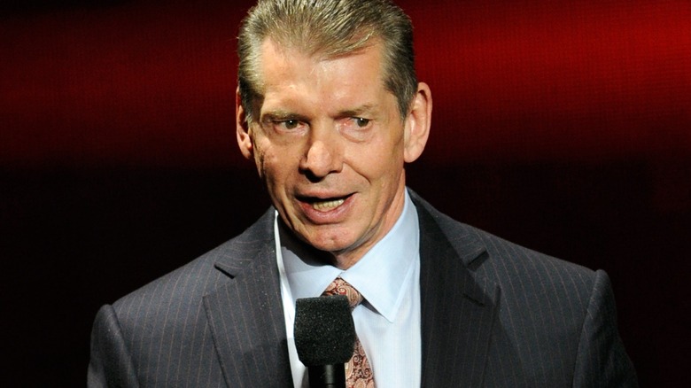 Vince McMahon holding a microphone