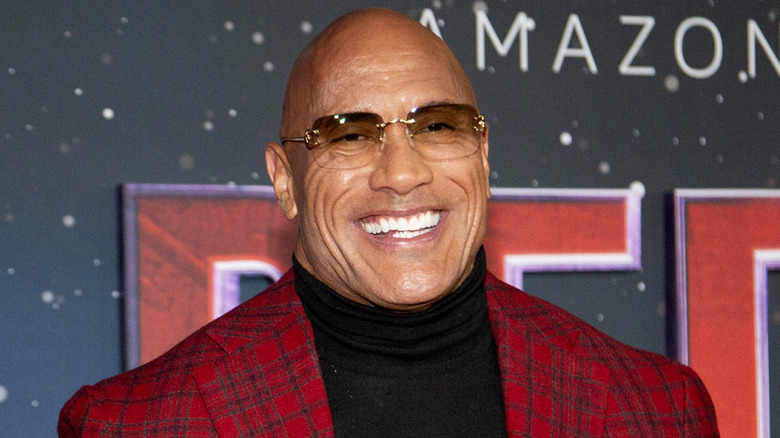 The Rock in a red jacket promoting Red One