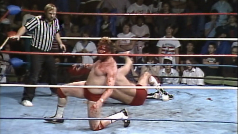 A bloody Ted DiBiase faces Ric Flair