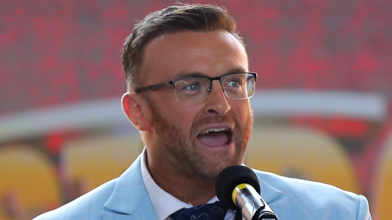 Nick Aldis speaks at an event 