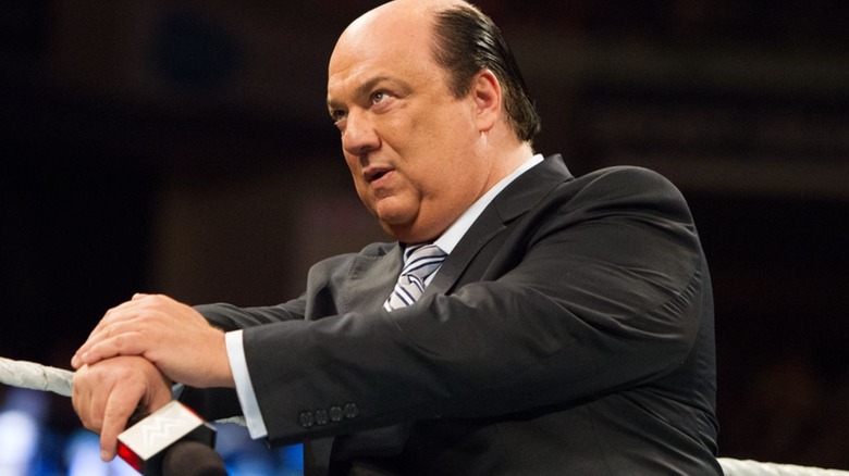 Paul Heyman stands on the ring apron, microphone in hand, during an episode of "WWE SmackDown."