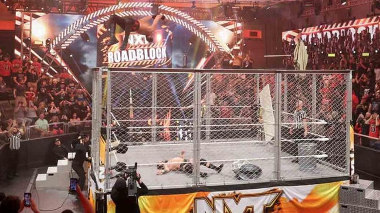 Dijak hits a moonsault off the top of a cage during an Asylum Match against Joe Gacy on WWE NXT