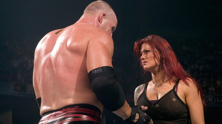 Kane stares down Lita in the middle of the ring 