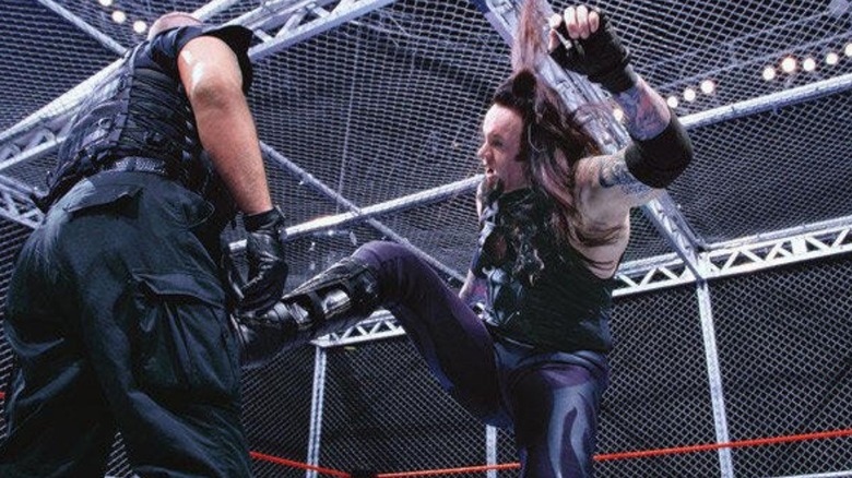 Undertaker kicks Big Boss Man in the stomach 