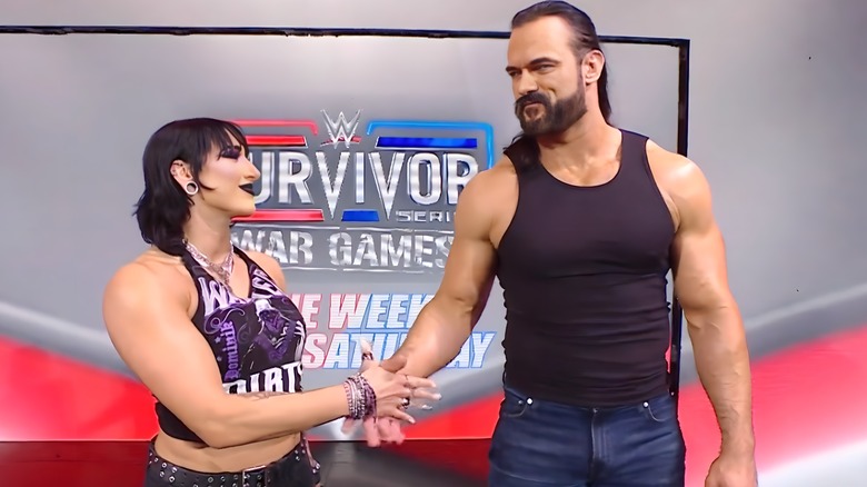 Rhea Ripley shakes hands with Drew McIntyre