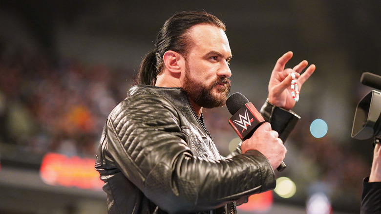 Drew Mcintyre holding CM Punk's bracelet