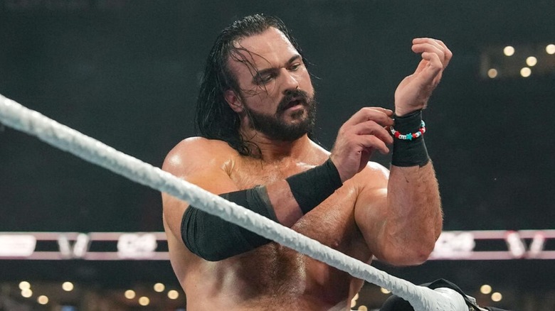 Drew McIntyre puts the friendship bracelet bearing the names of CM Punk's wife and dog around his wrist during their match at WWE SummerSlam.