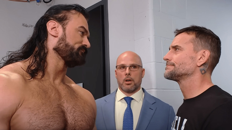 Drew McIntyre and CM Punk with Adam Pearce