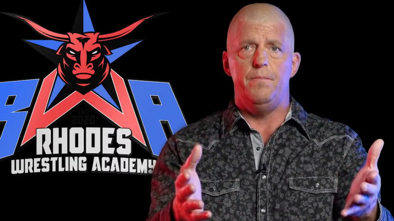 Dustin Rhodes with Rhodes Wrestling Academy logo