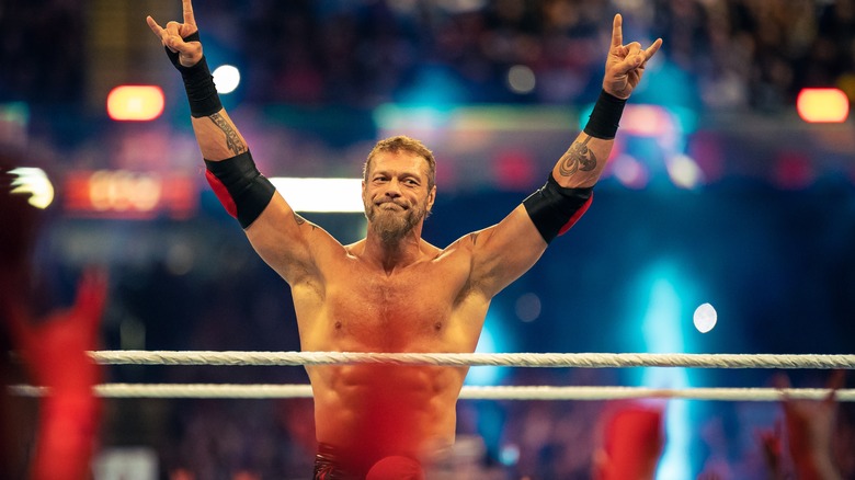 Edge holding up his arms