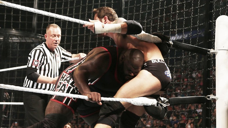 Mark Henry and Wade Barrett doing what they can to keep the 2015 Elimination Chamber match going.