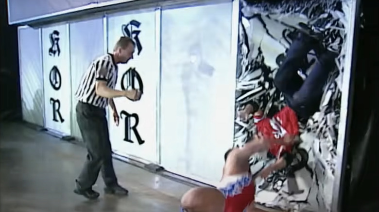 Kurt Angle launches Shane McMahon through a plexiglass window.