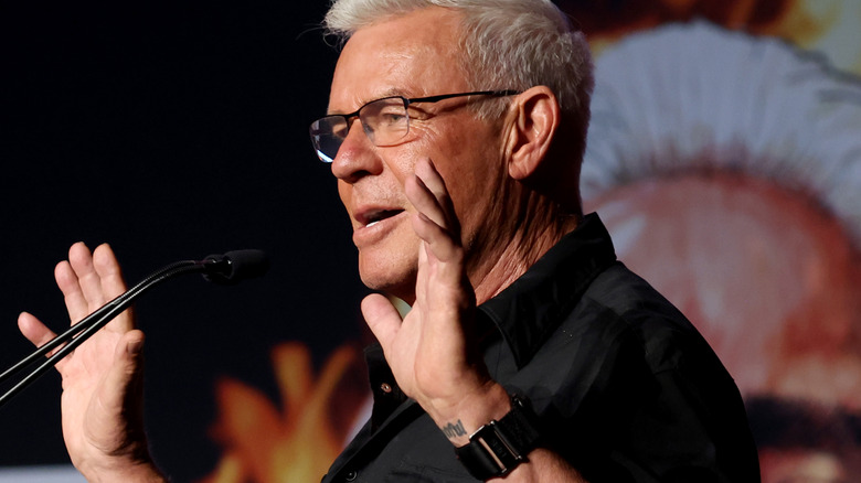 Eric Bischoff with his hands up