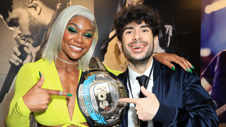 Tony Khan poses with Jade Cargill