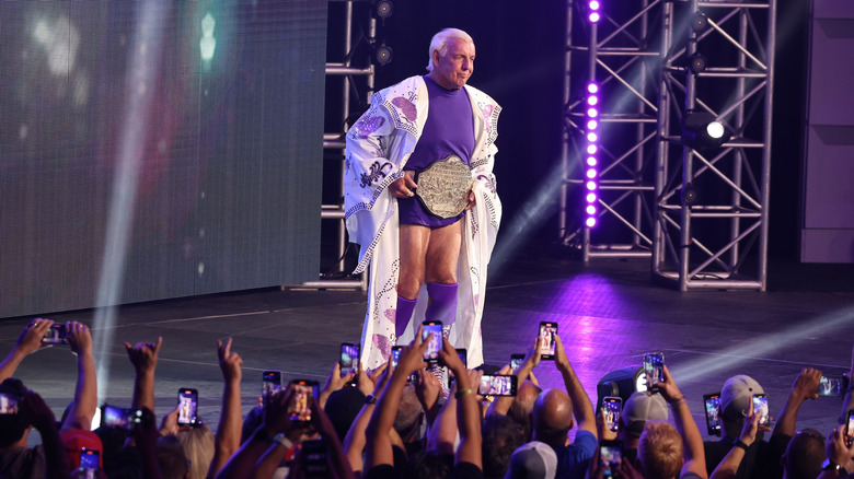 Ric Flair makes an entrance while fans film him