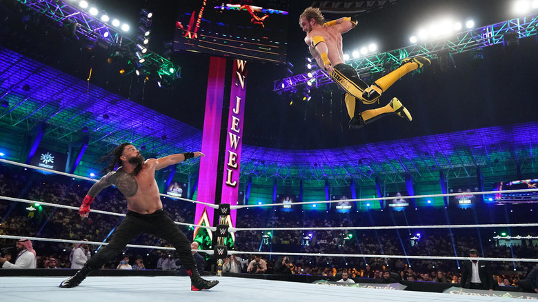 Logan Paul flies toward Roman Reigns