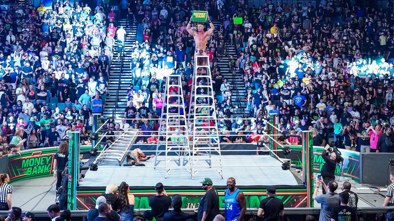 Austin Theory raises briefcase atop ladder