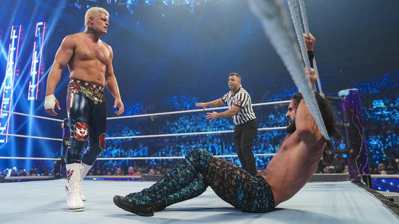 Cody Rhodes stands over Seth Rollins