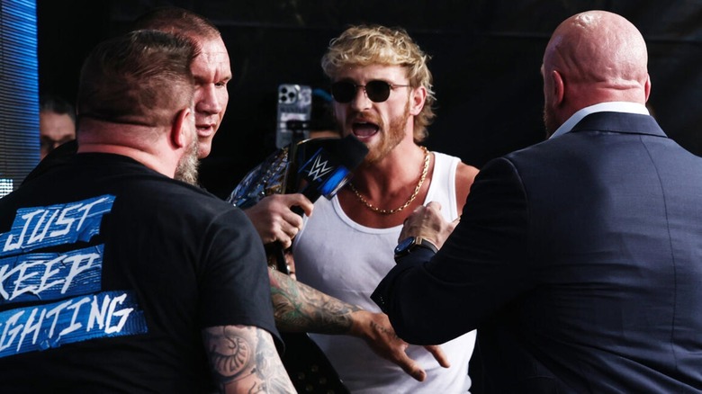 Logan Paul confronts Kevin Owens, with Randy Orton also there