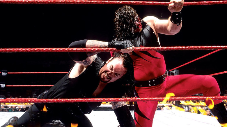 Kane fights Undertaker with ring on fire