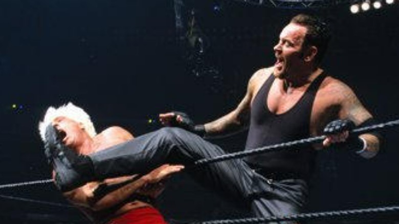 Undertaker kicks flair