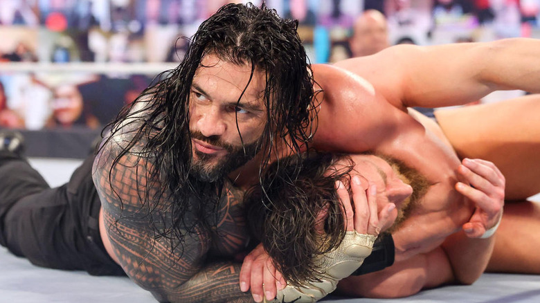 Roman Reigns chokes Daniel Bryan