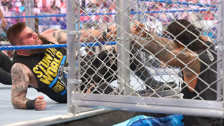 Roman Reigns fights Kevin Owens in cage