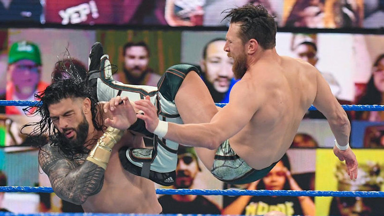 Daniel Bryan dropkicks Roman Reigns