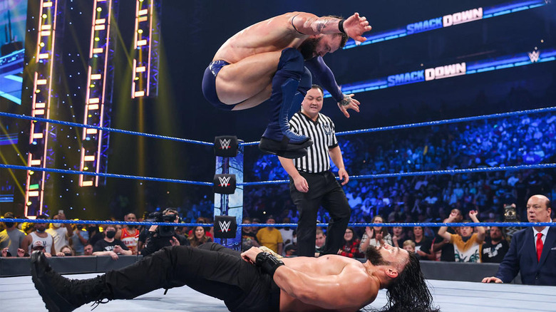 Finn Balor jumps on Roman Reigns