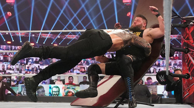 Roman Reigns spears Kevin Owens through table