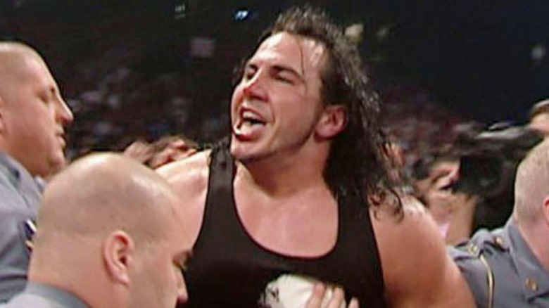 Matt Hardy being escorted out of an arena